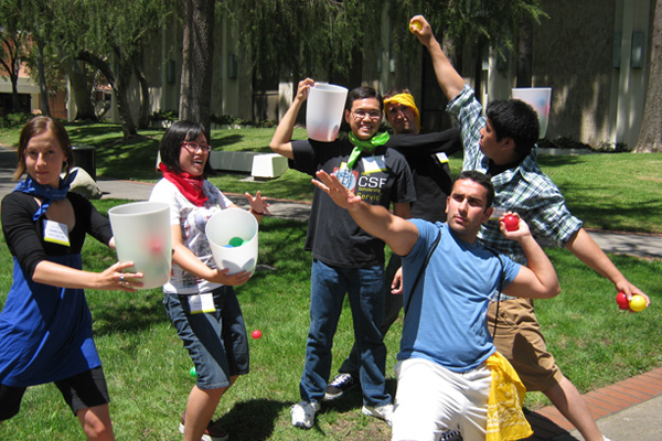 Students showing off the game equipment for our epic team building challenge No Match Catch