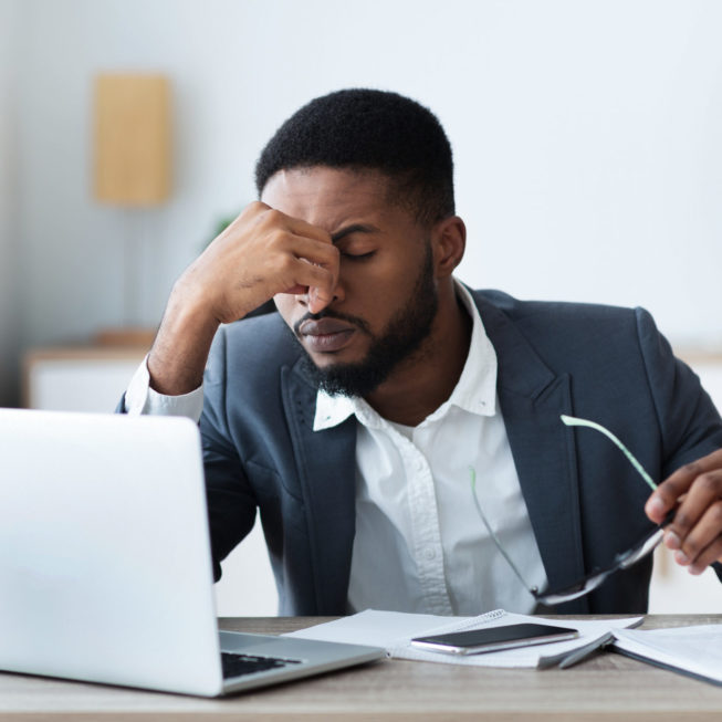 African businessman working remotely frustrated team member needing team building exercises